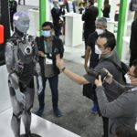 CES attendees interacting with a robot that looks like a human