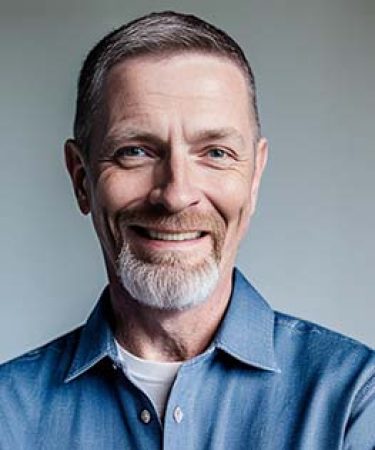 This is a headshot of Casey McMullen, who provides a concise guide to AI within the event tech industry in this article.