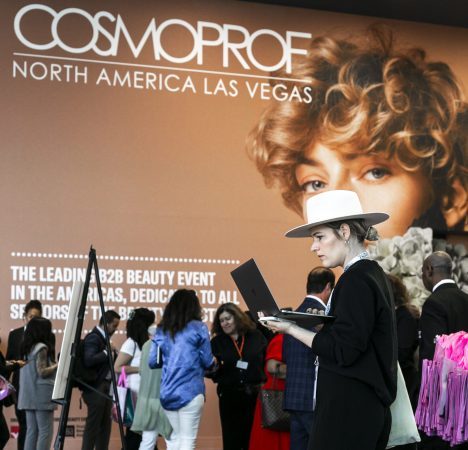 photo of people in front of a Cosmoprof North America backdrop