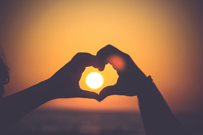 photo of two hands making a heart shape in celebration of giving tuesday