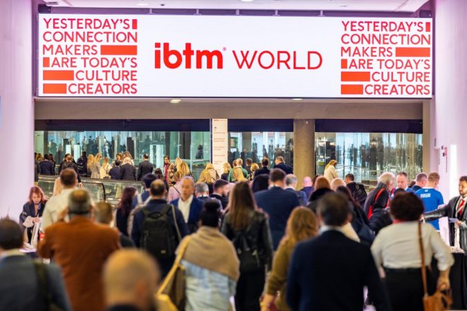 Photo from IBTM World 2022 of people walking into an exhibition hall