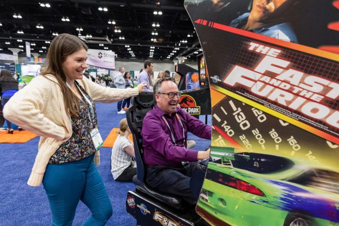 image of people playing a racing game at NatCon 23 play area