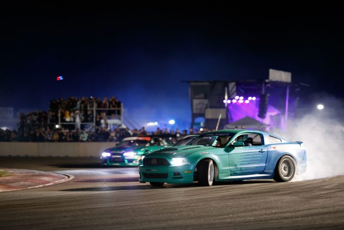 photo of two cars racing in the streets