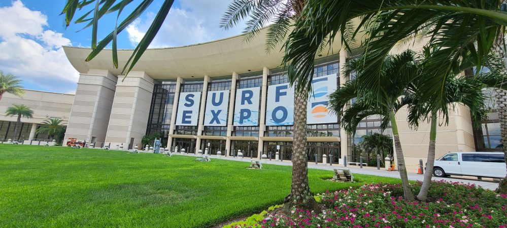 the outside of the orange county convention center with banners that read "Surf Expo"