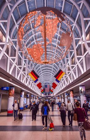 the u.s. travel association projects travel frustrations; image includes flags from many countries in an atrium