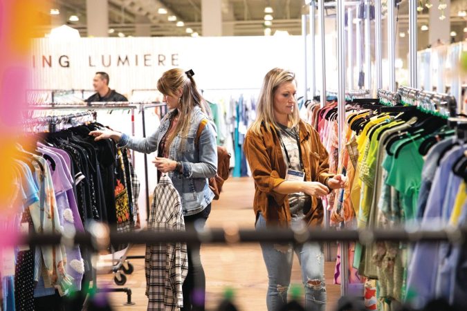 two people looking through racks of clothes at Las Vegas Apparel