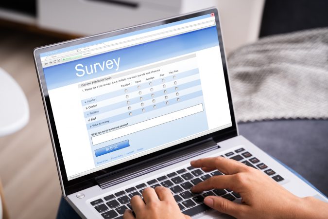 image of a person taking a survey on their laptop