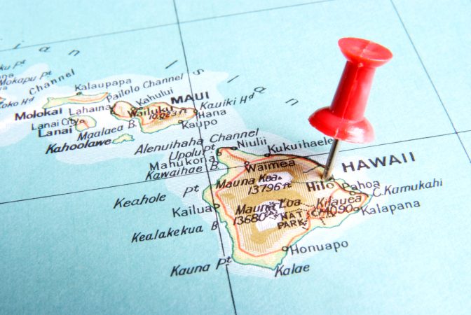 Red pin stuck to map of Hawaii