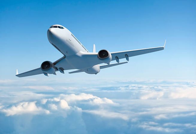 Mid-sized passanger airplane flying above clouds.