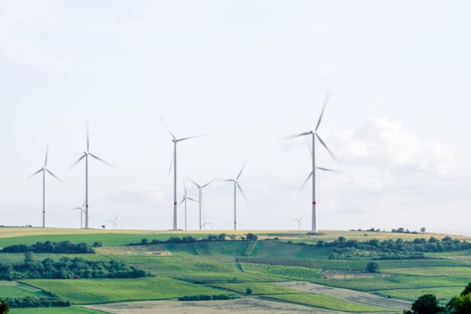 sustainable wind mills in a big field